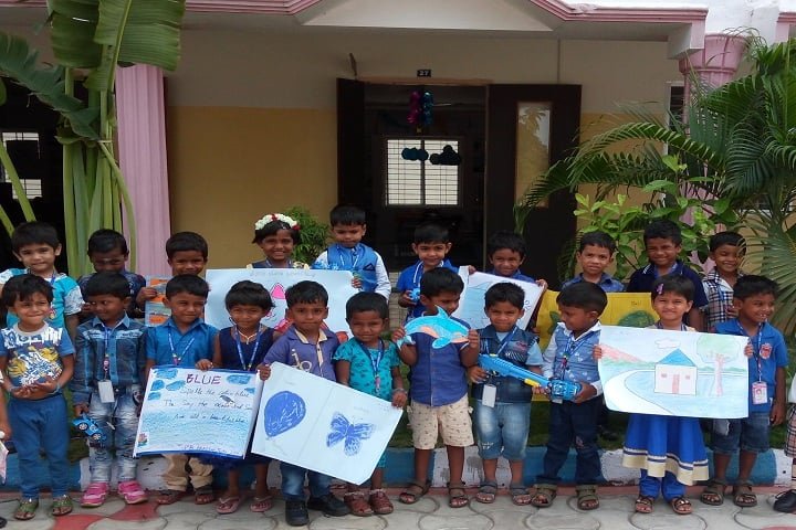 Kindergarten children holding up Blue Day drawings